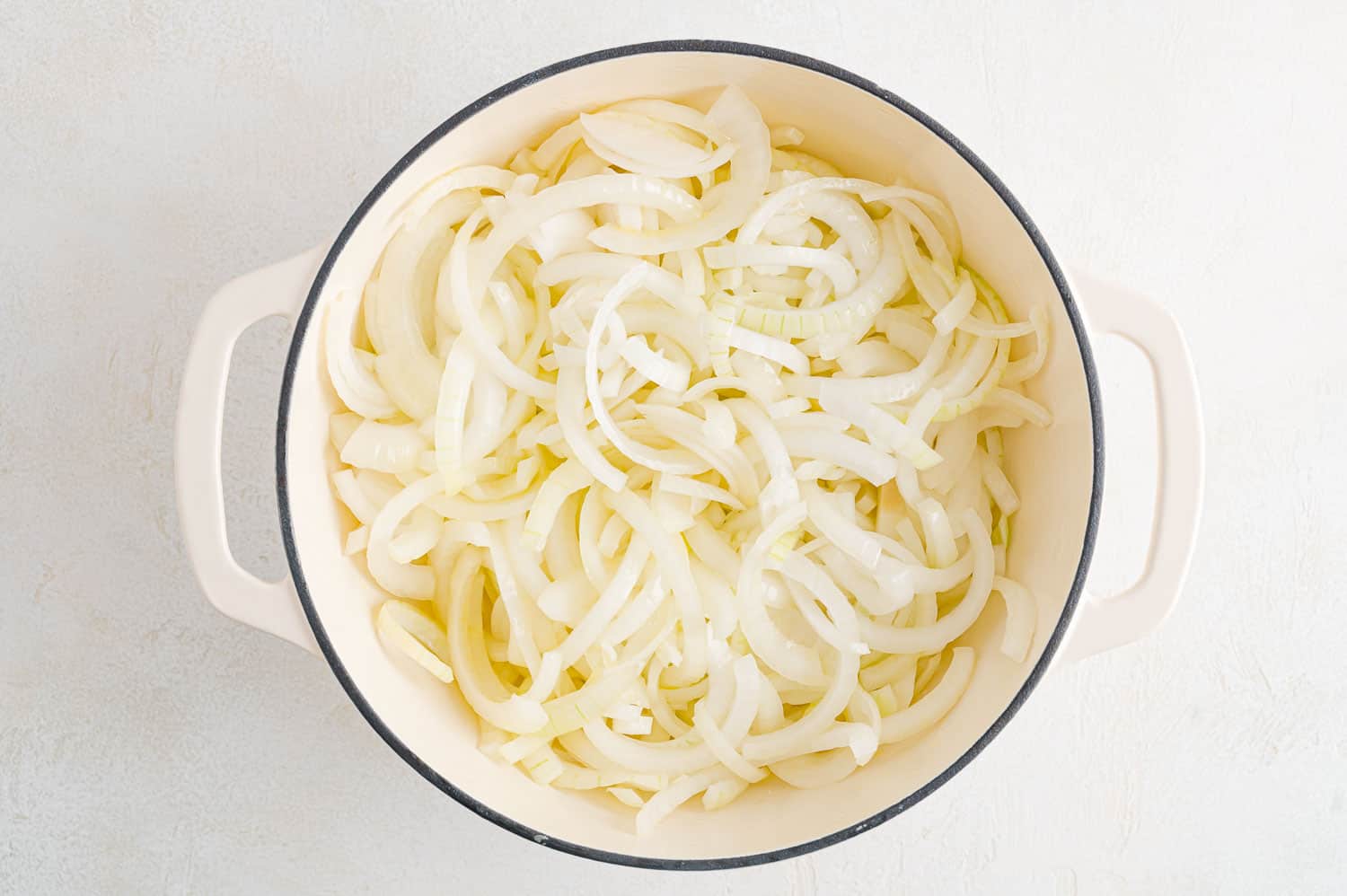 Uncooked onions in a dutch oven.