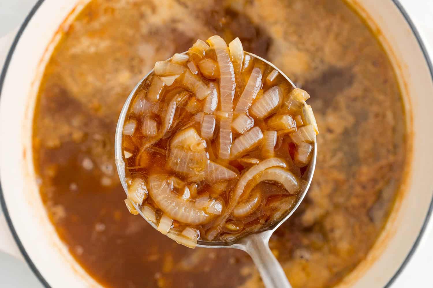 Onion soup in a ladle.