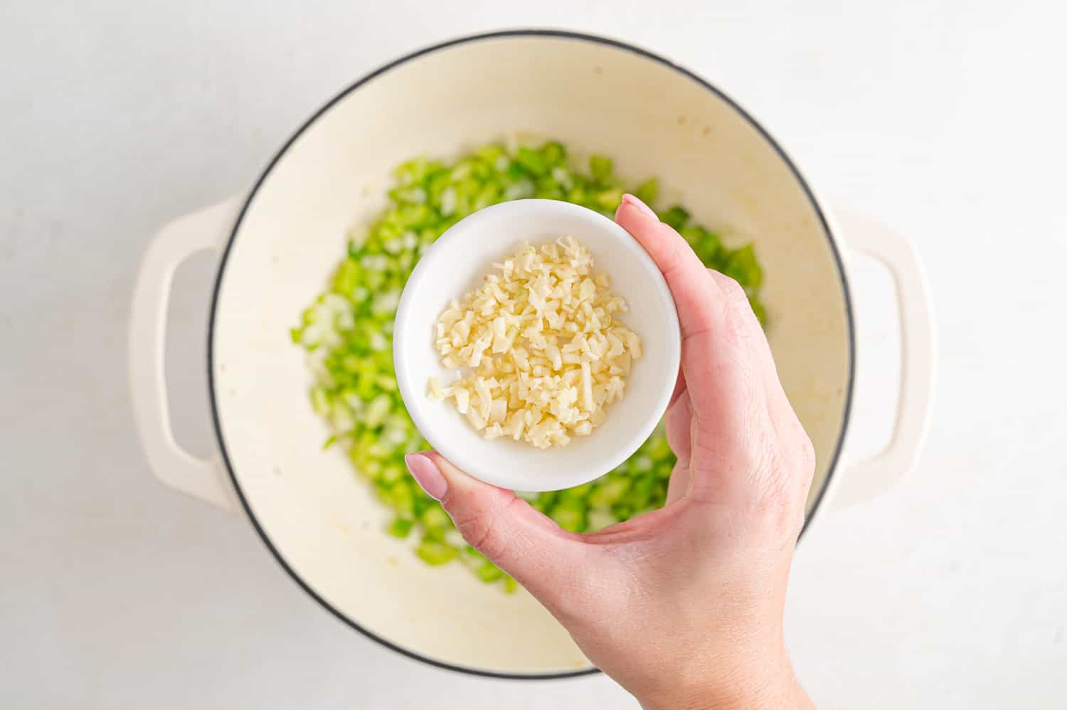 Minced garlic being added to the pan.