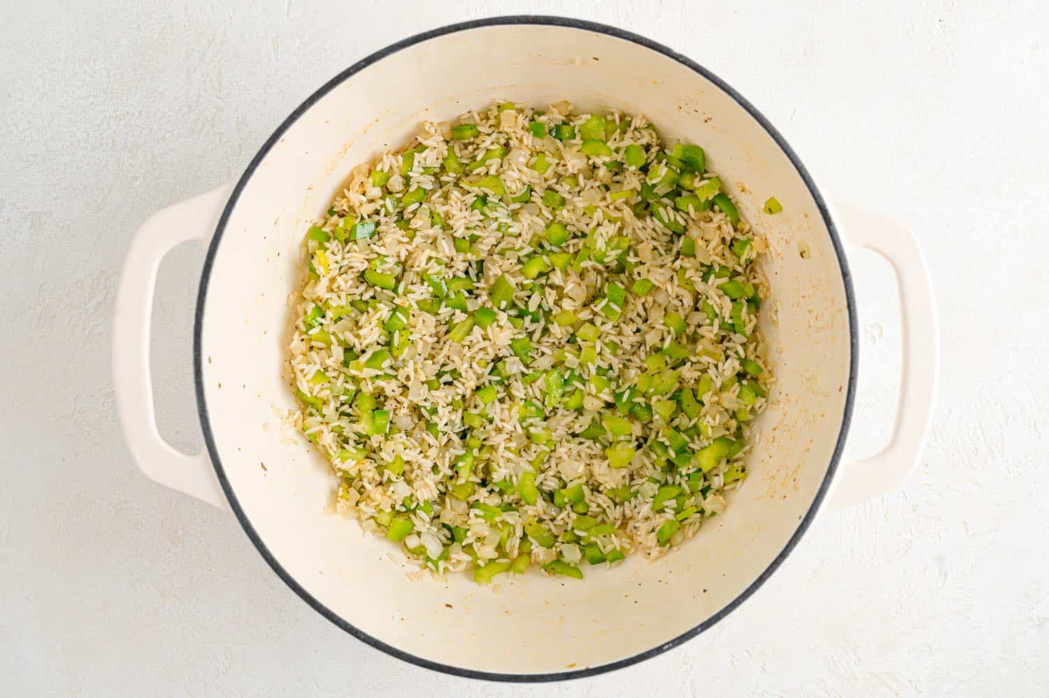 Rice and seasonings added to pan.