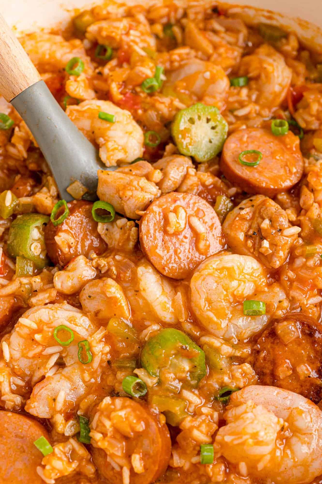 Jambalaya in a pan with serving spoon.