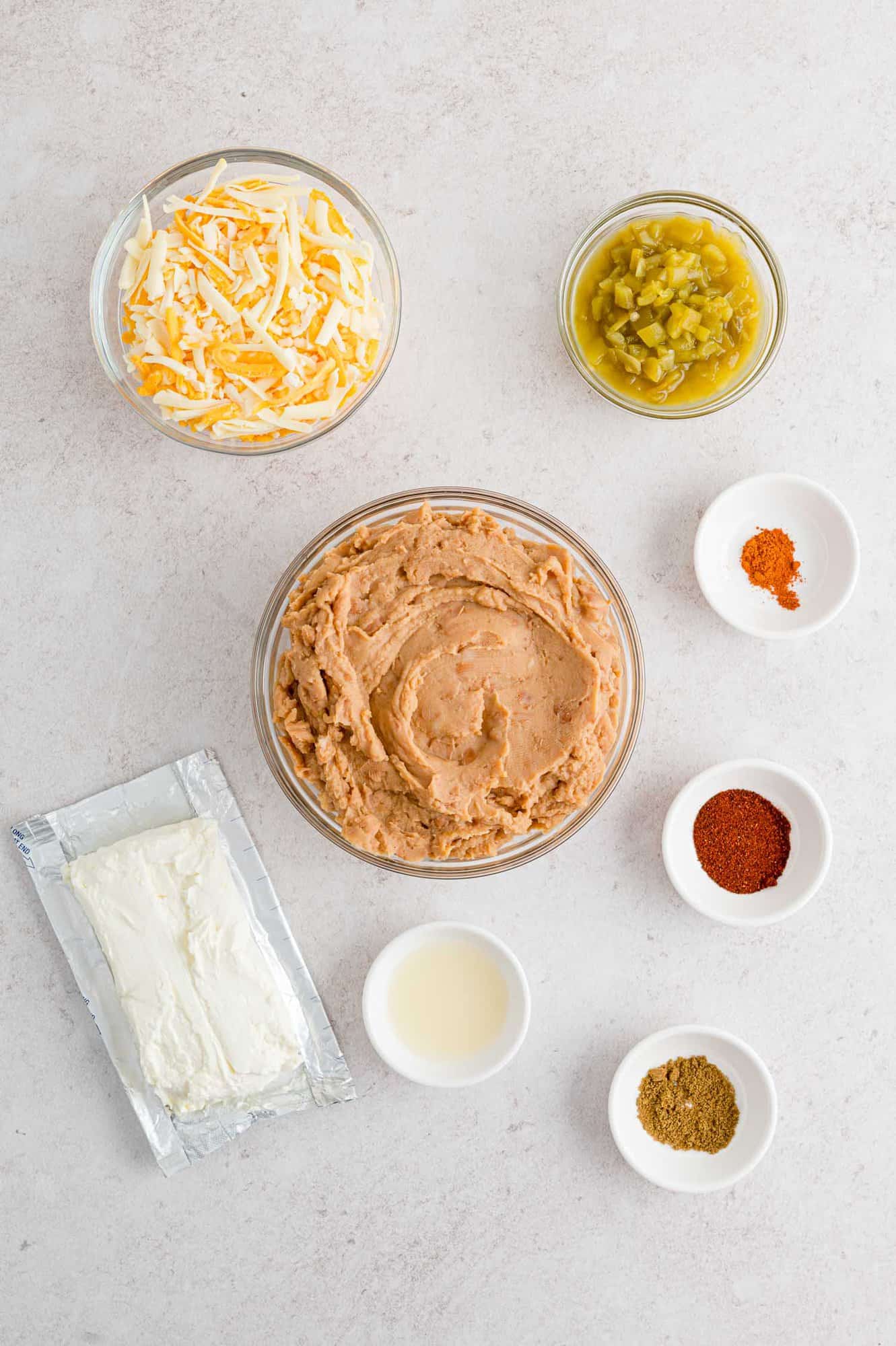 Ingredients needed for recipe including refried beans and cream cheese.