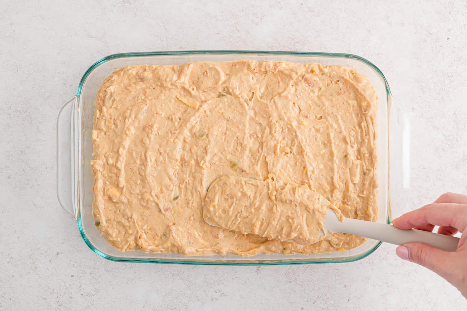 Bean dip spread into a baking dish.