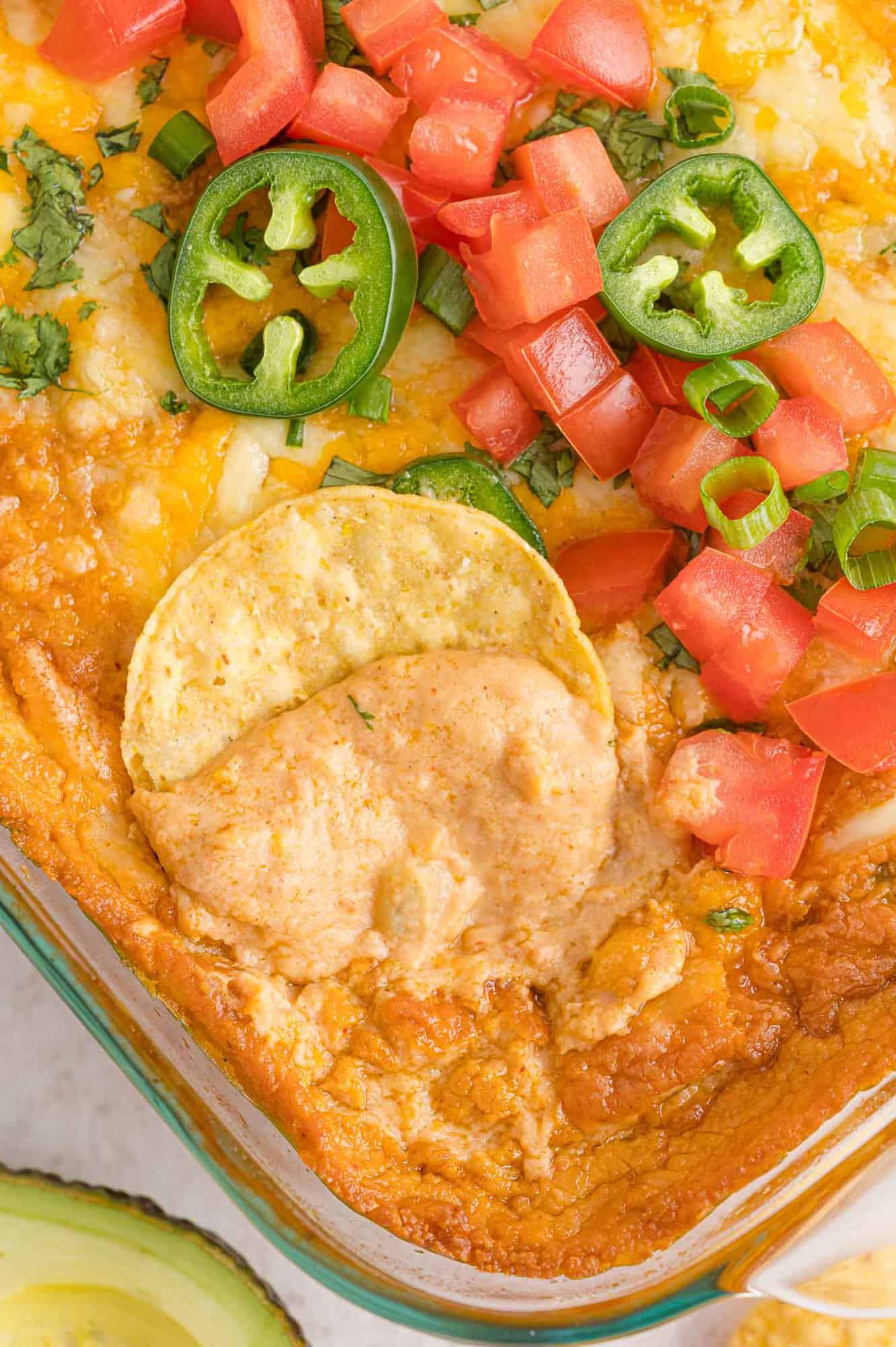 Chip being dipped into bean dip.