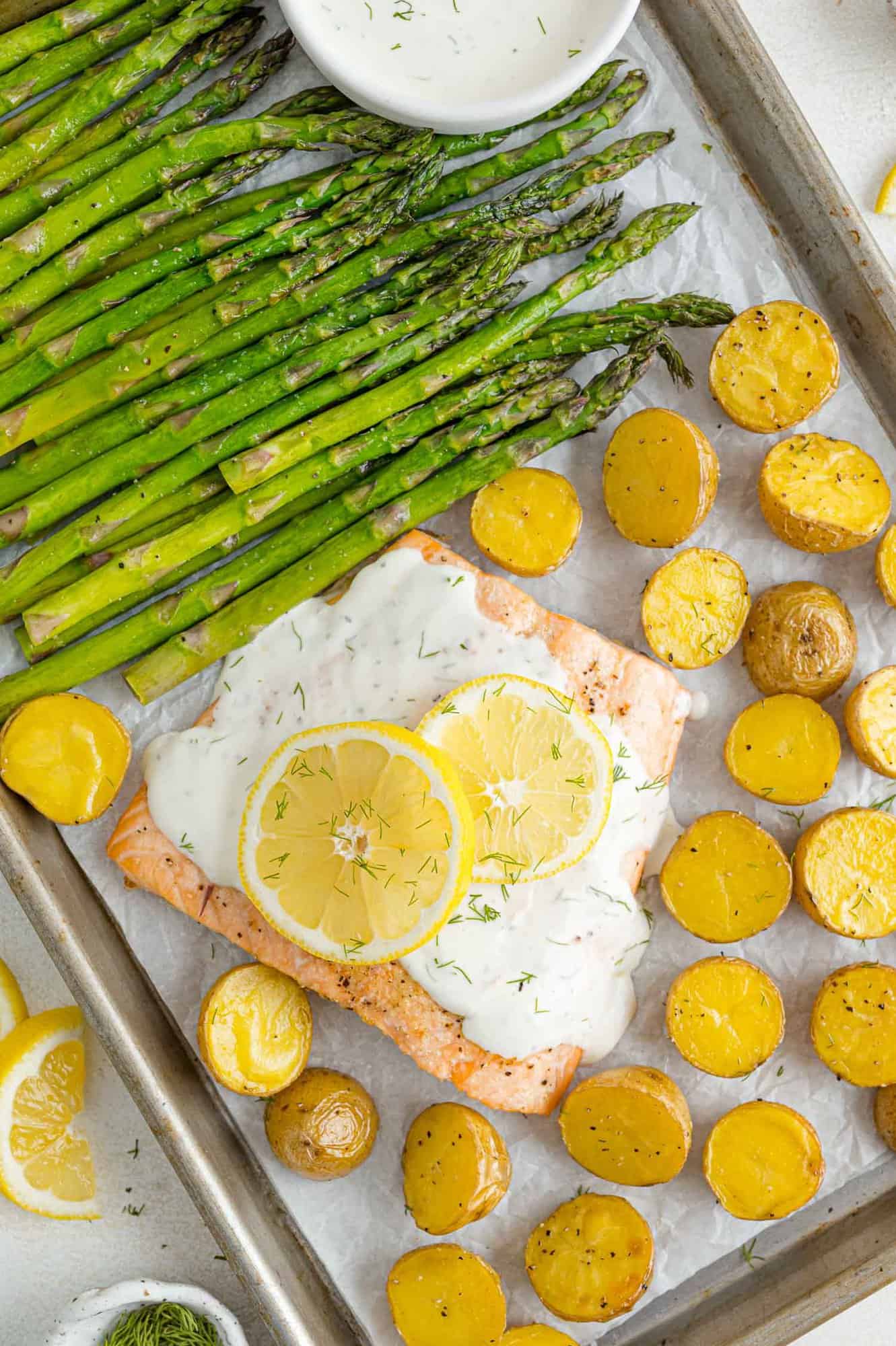 Overhead view of a salmon sheet pan dinner with asparagus and potatoes.