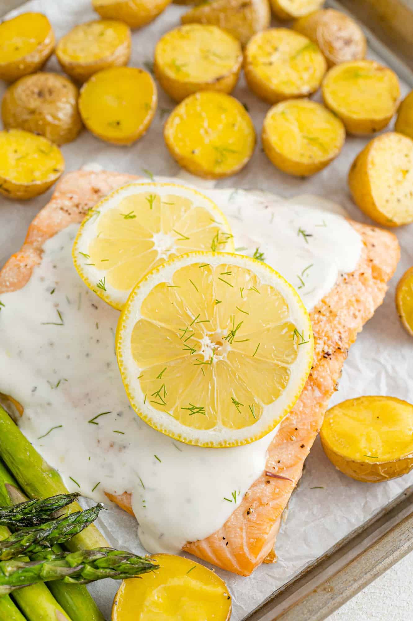 Salmon with lemon dill sauce, potatoes on same pan.