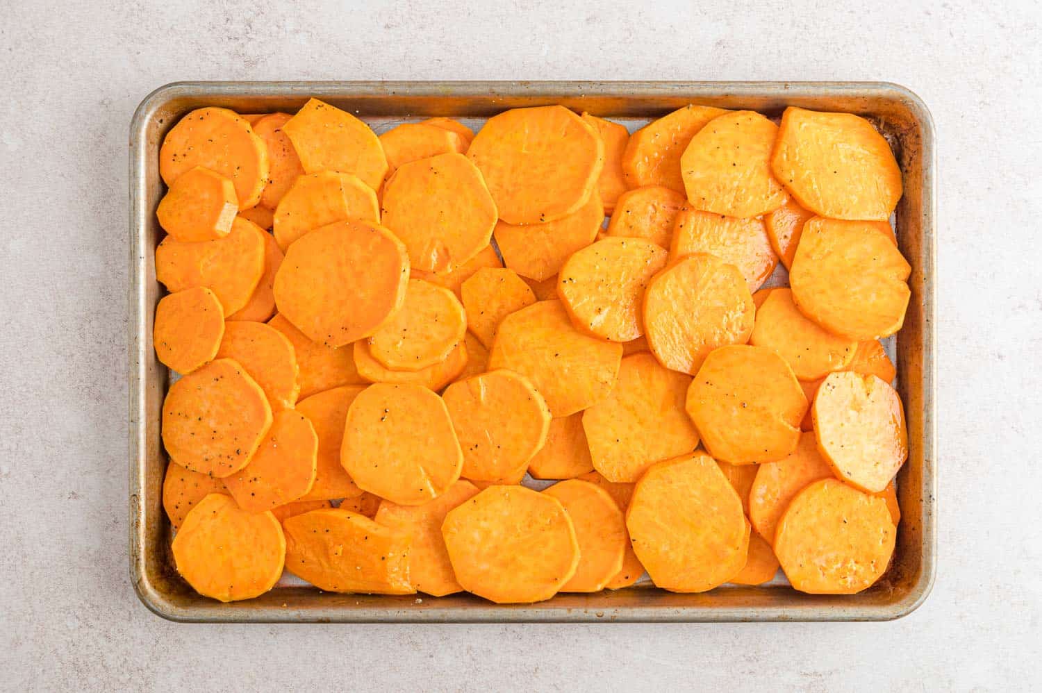 Sweet potato slices on roasting pan.