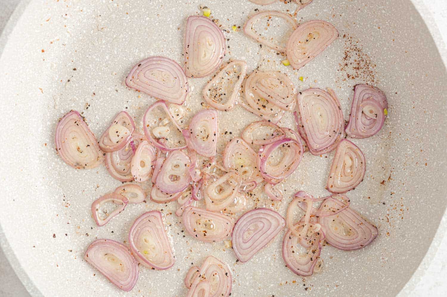 Shallots in frying pan.