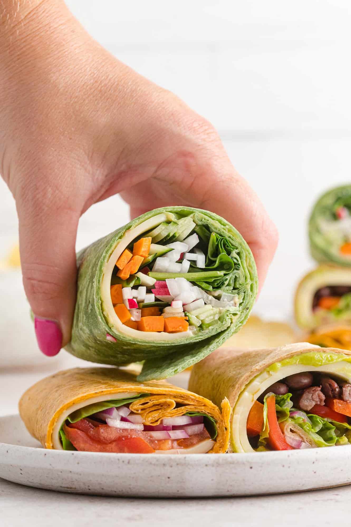 Wrap with vegetable filling being held in a hand.