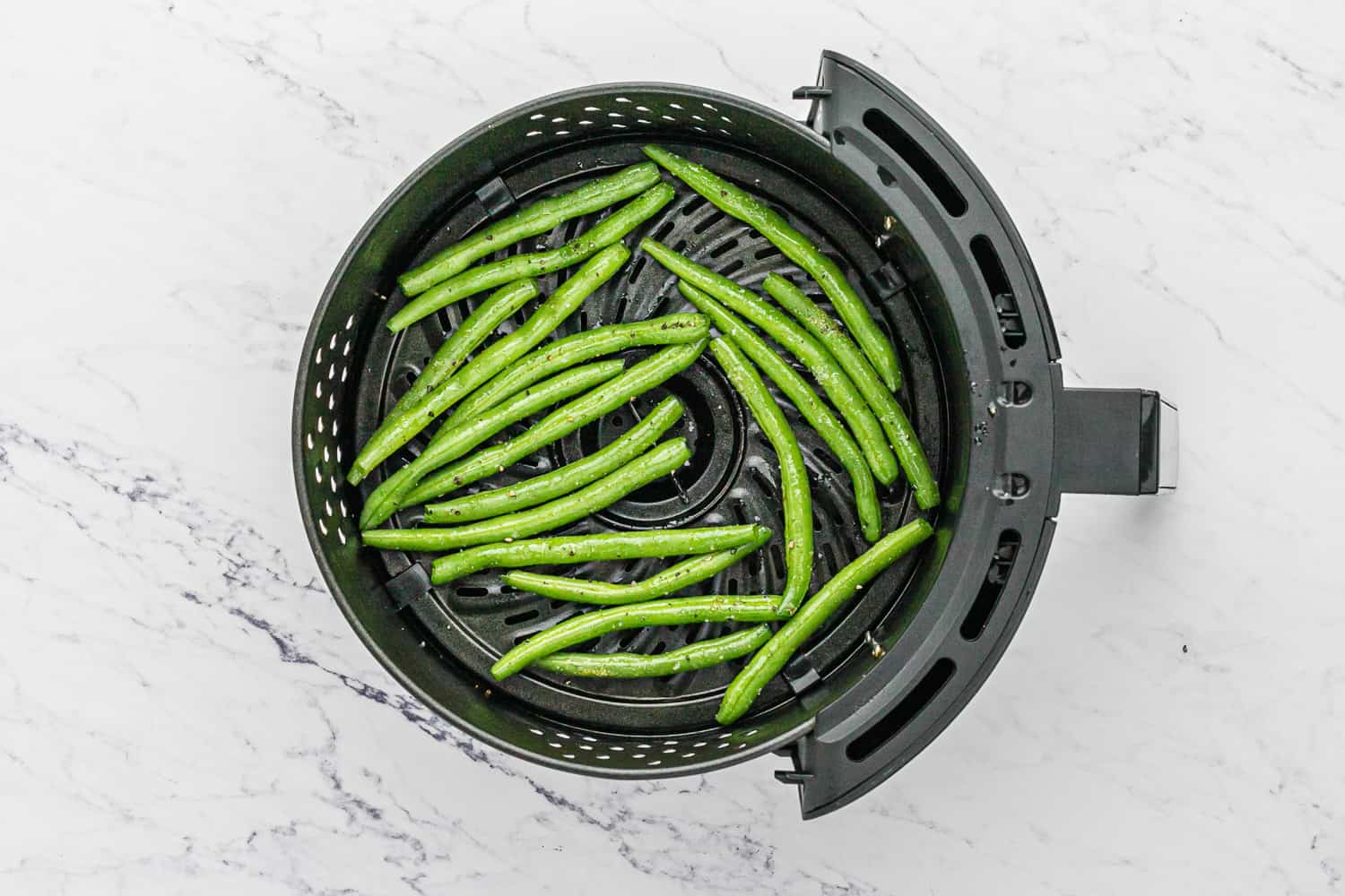 Uncooked beans in an air fryer.