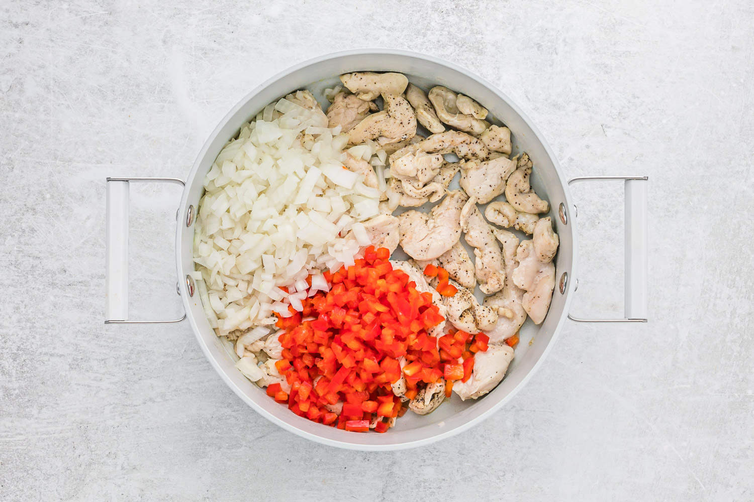 Peppers and onions added to the pan.