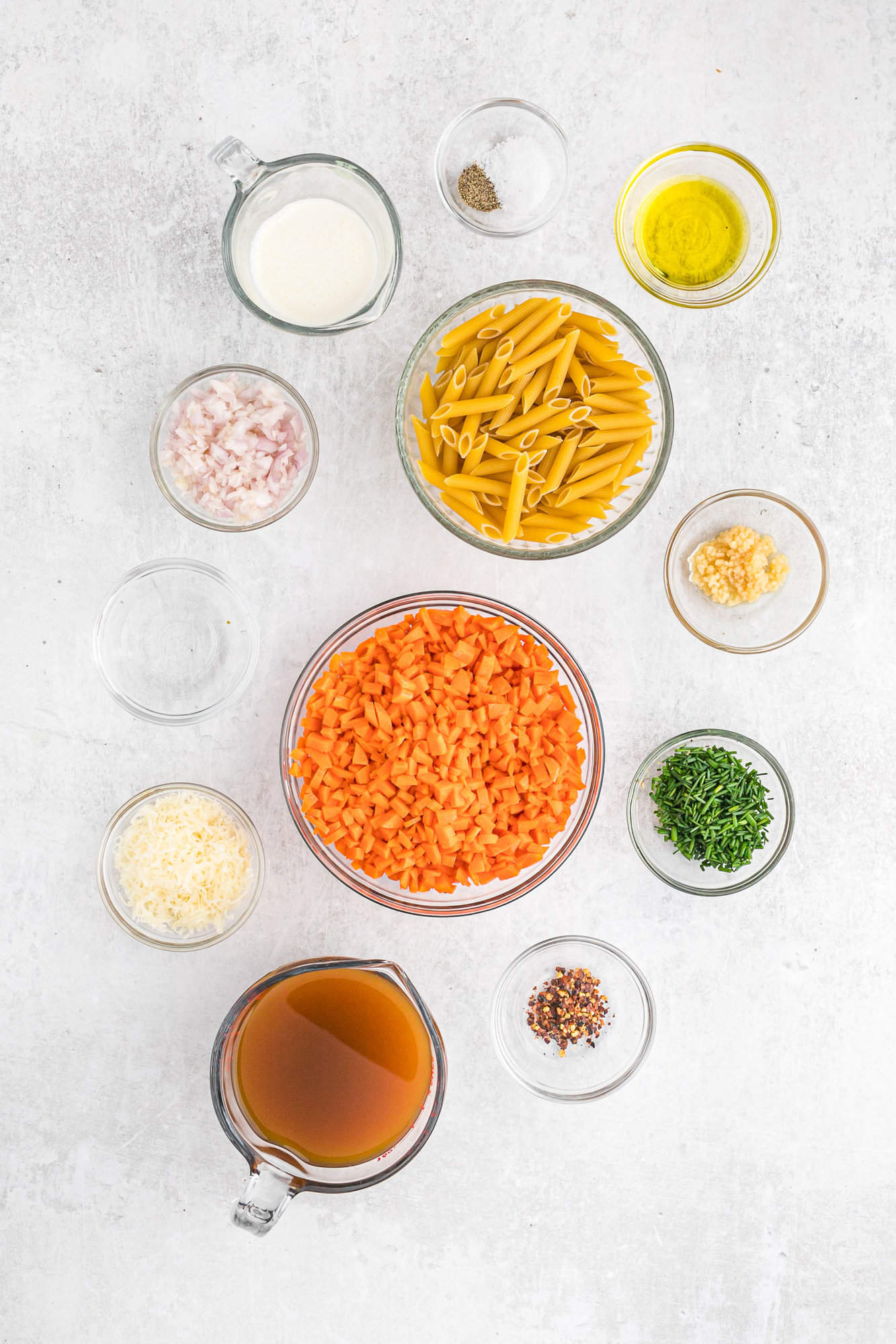 Ingredients needed, in separate bowls, including carrots and chives.