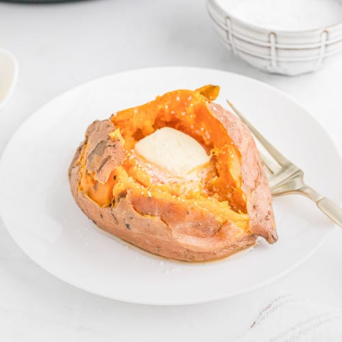Instant pot sweet potato with butter melting inside it.