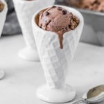 No churn double chocolate ice cream in a white ceramic cone.