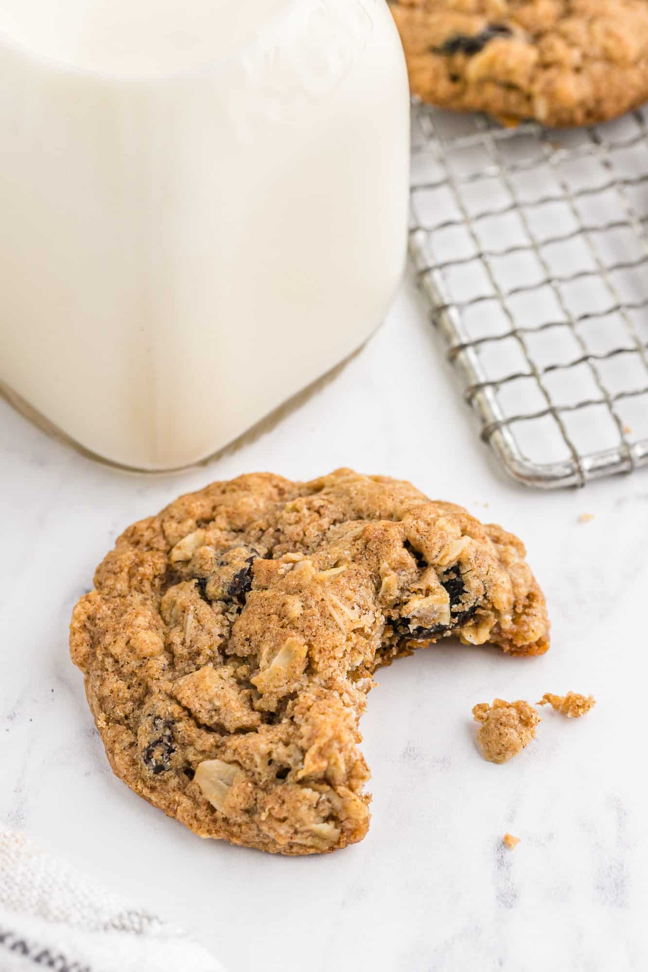 Oatmeal raisin cookie with a bite taken from it.