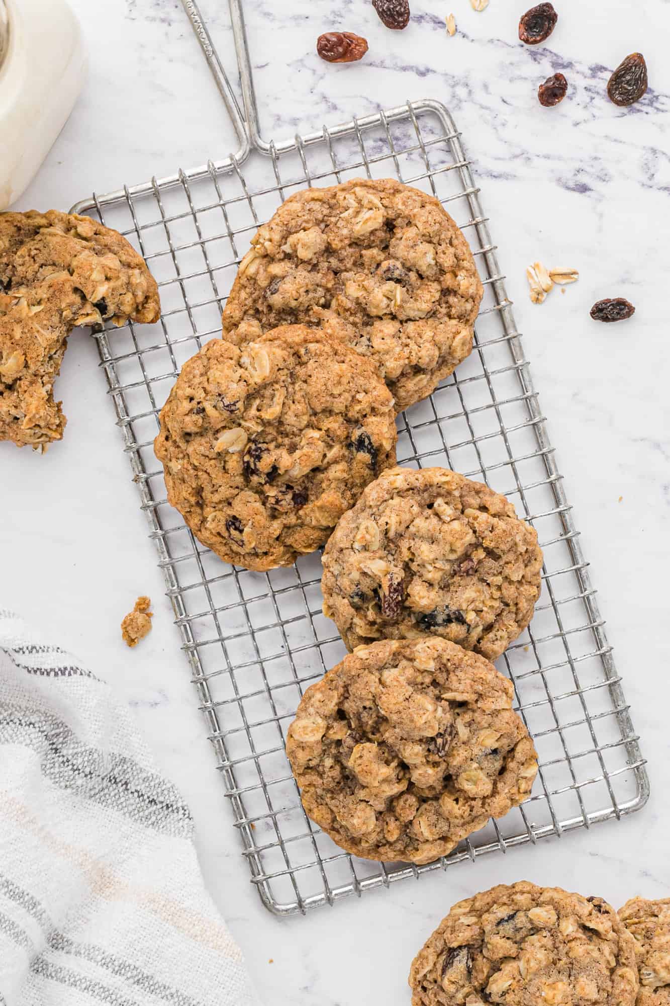 Oatmeal raisin cookies on a cooling rack.