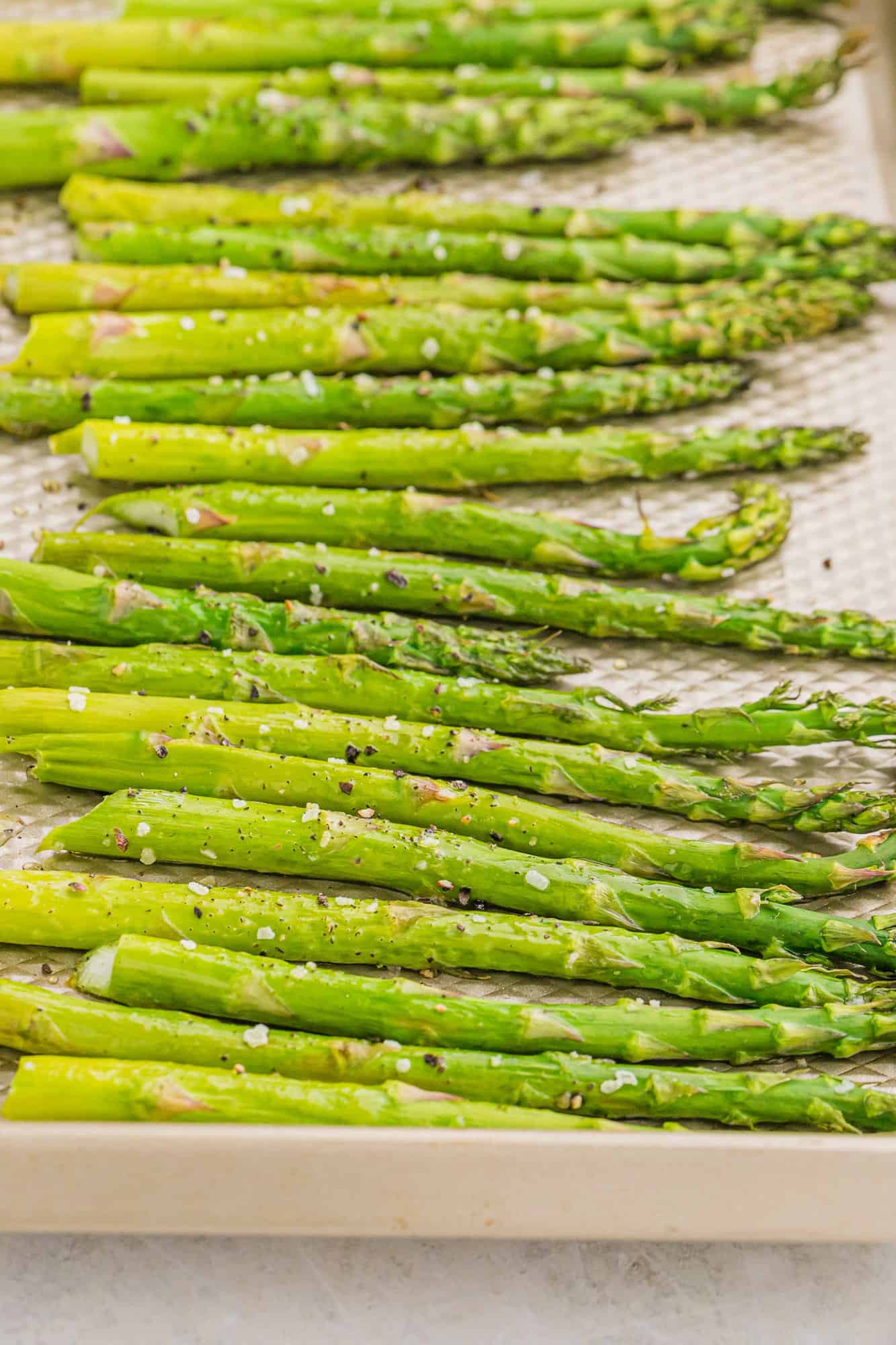 Roasted asparagus spears on a pan.