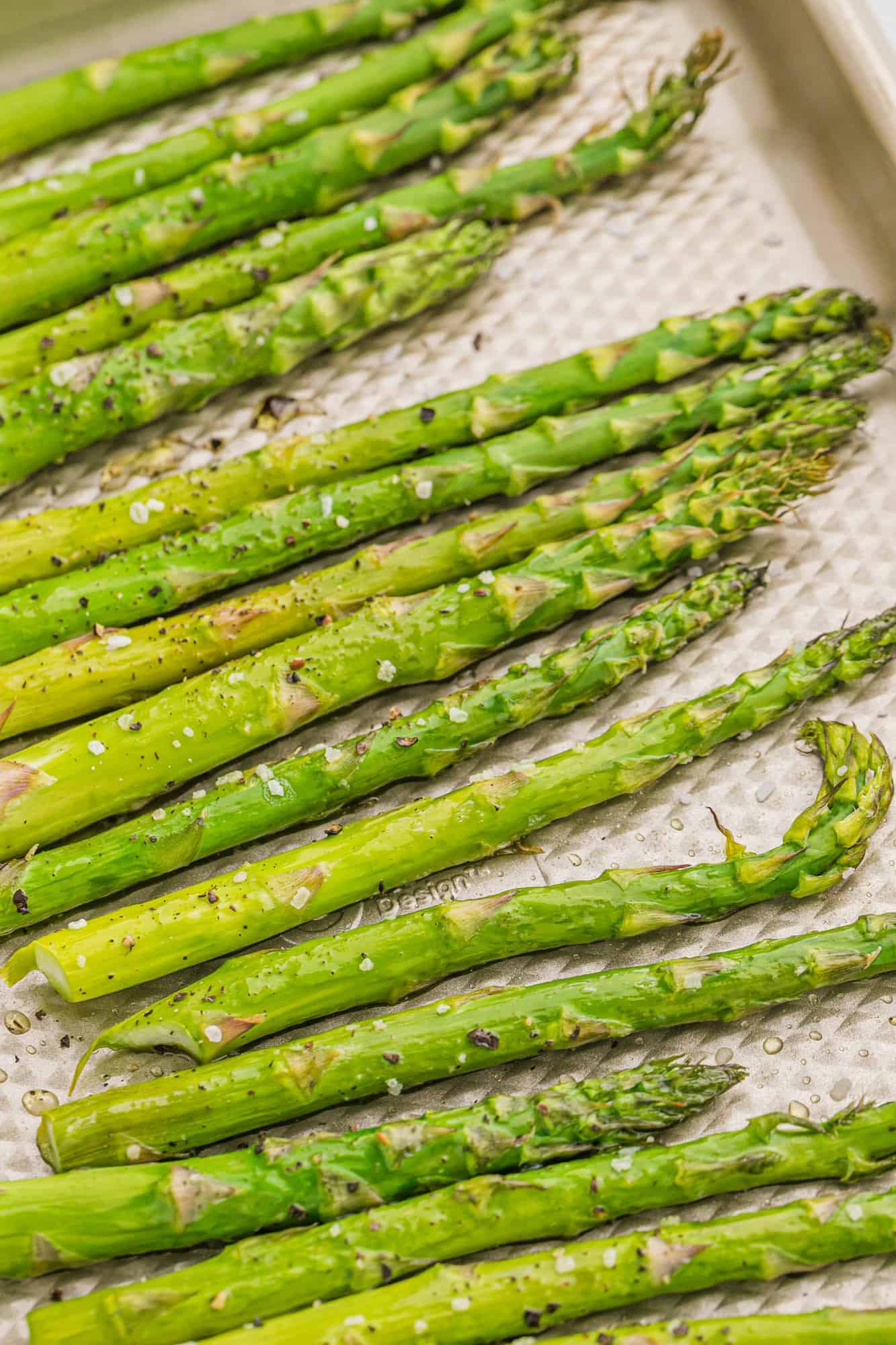 Roasted asparagus on a sheet pan.