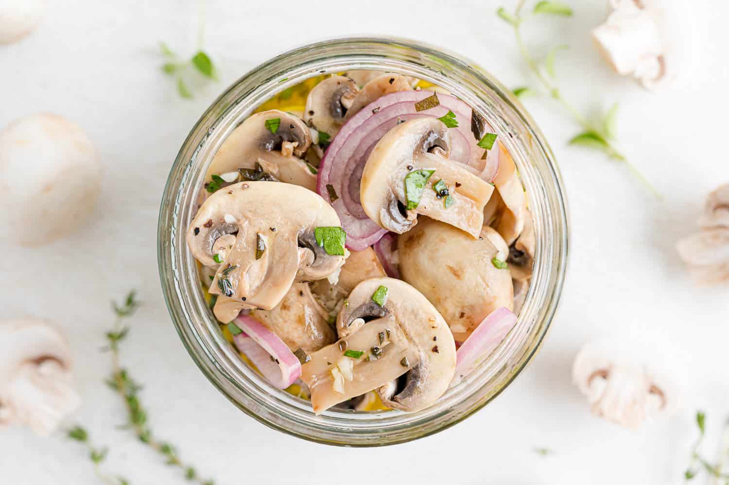 Overhead view of mushrooms in jar.