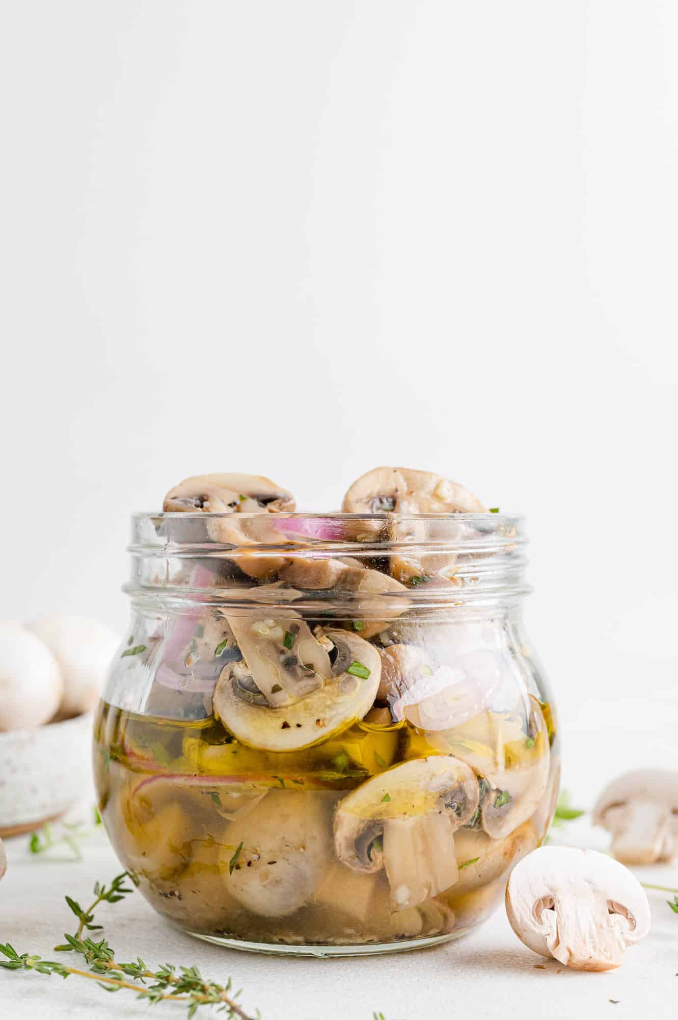 Marinated mushrooms in a small jar.