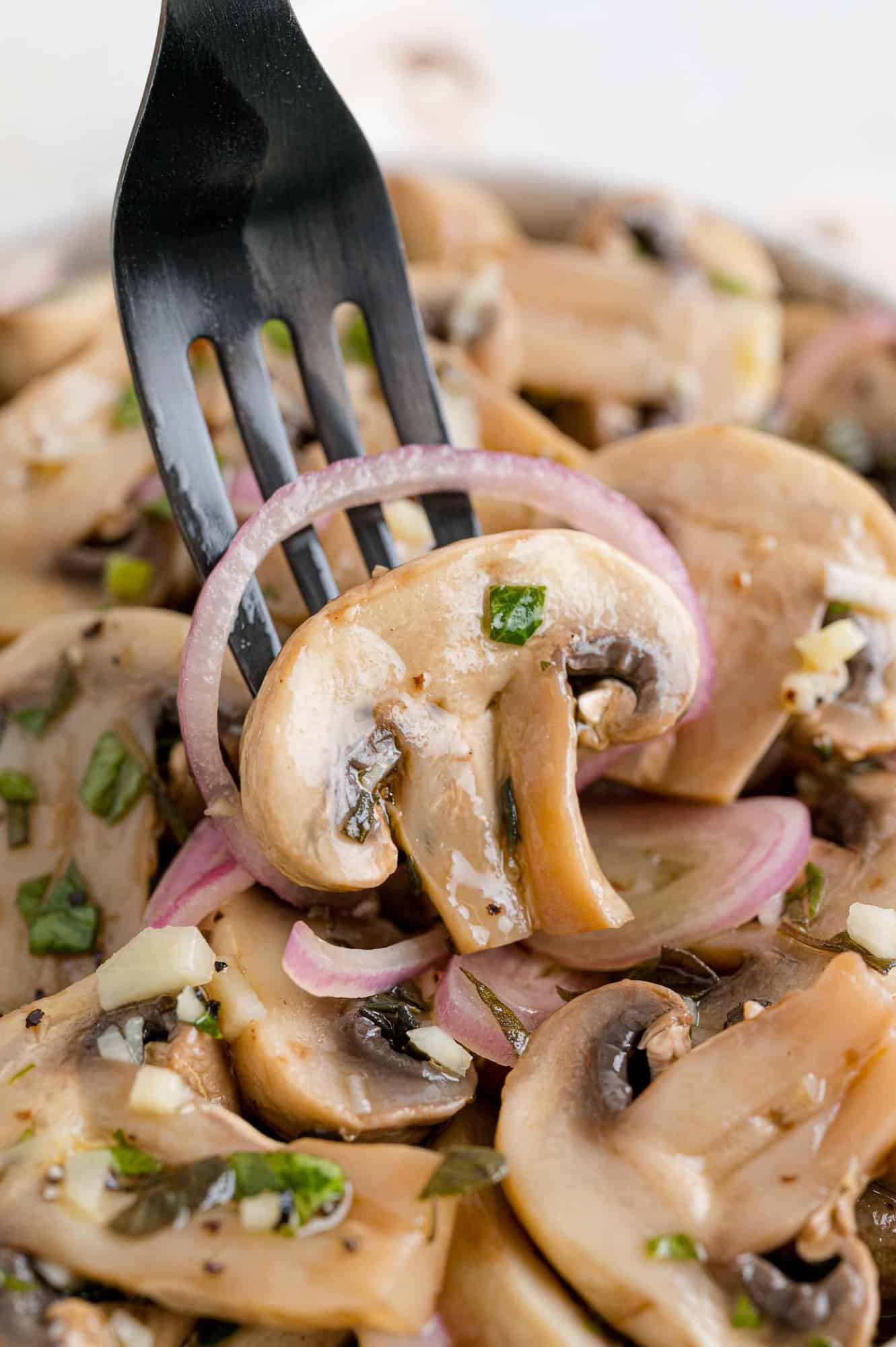 Marinated mushroom on a fork.