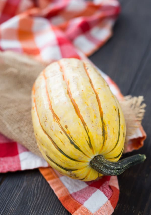 Uncooked and unsliced delicata squash.