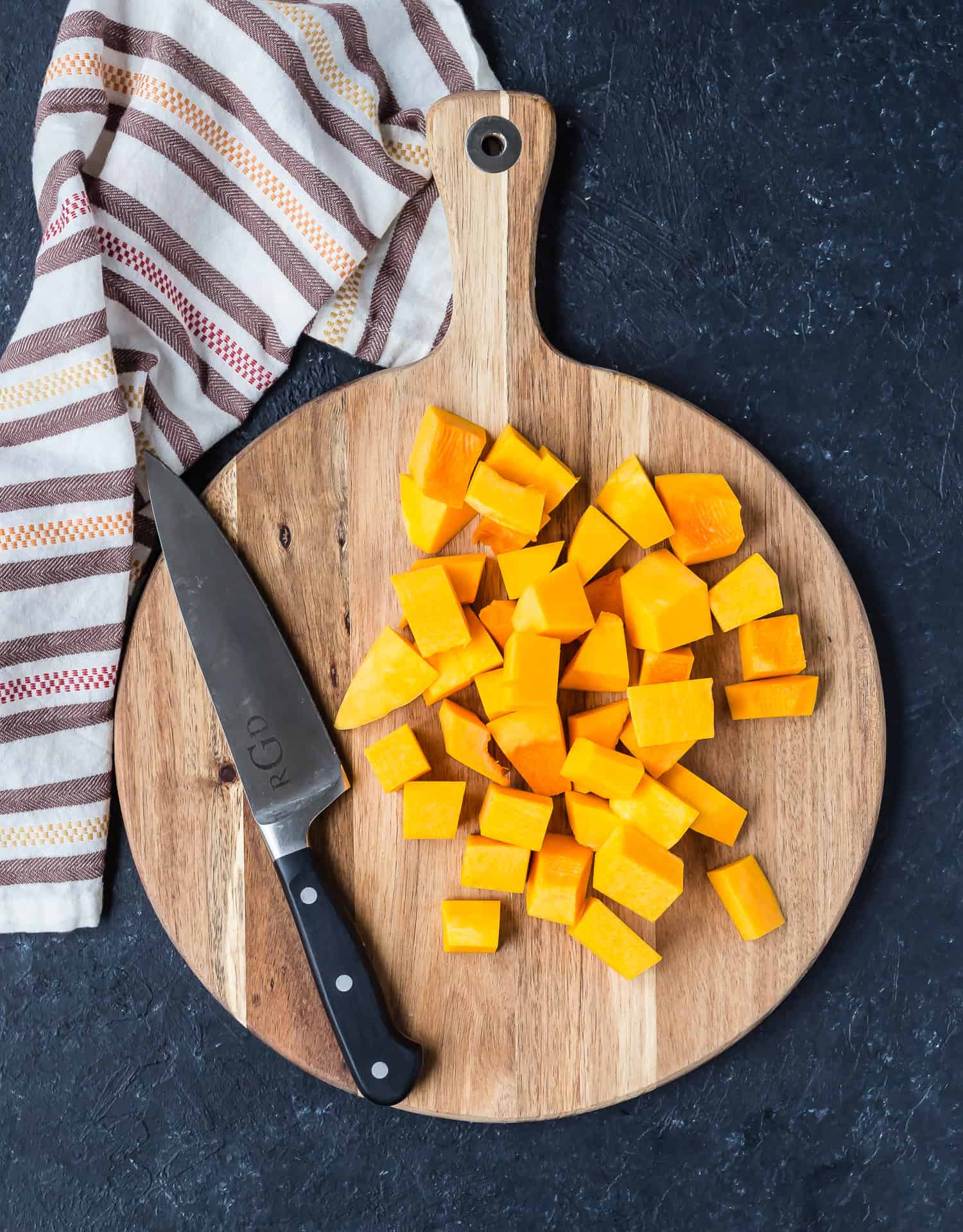 Diced butternut squash on a cutting board.