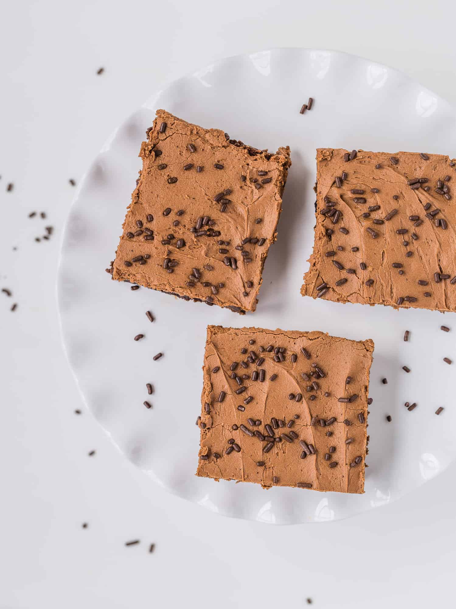 Overhead view of frosted brownies with sprinkles.