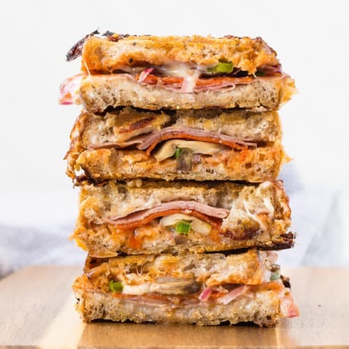 Stack of pizza paninis cut in half.