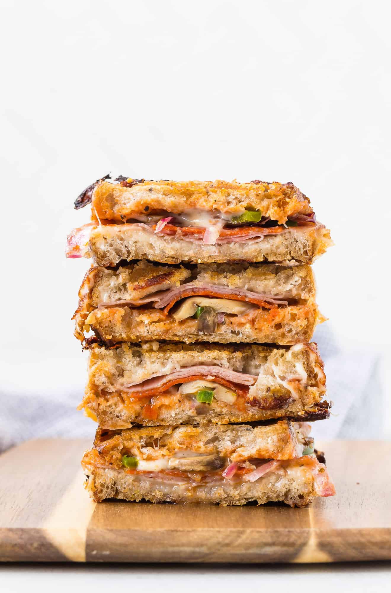 Stack of pizza paninis cut in half.