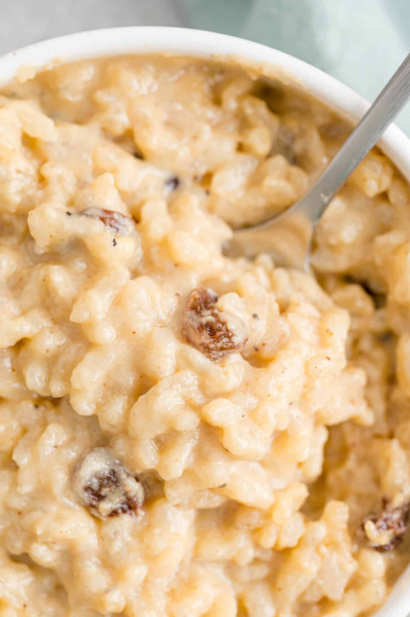 Rice pudding on a spoon and in a bowl.