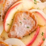 Pork tenderloin and apples garnished with thyme.