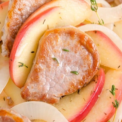 Pork tenderloin and apples garnished with thyme.