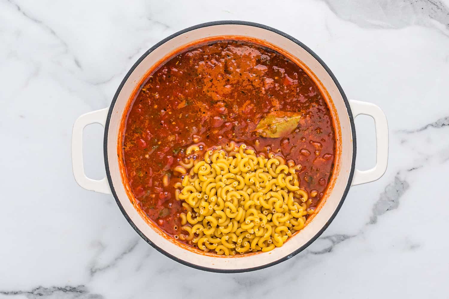Macaroni pasta added to pot.