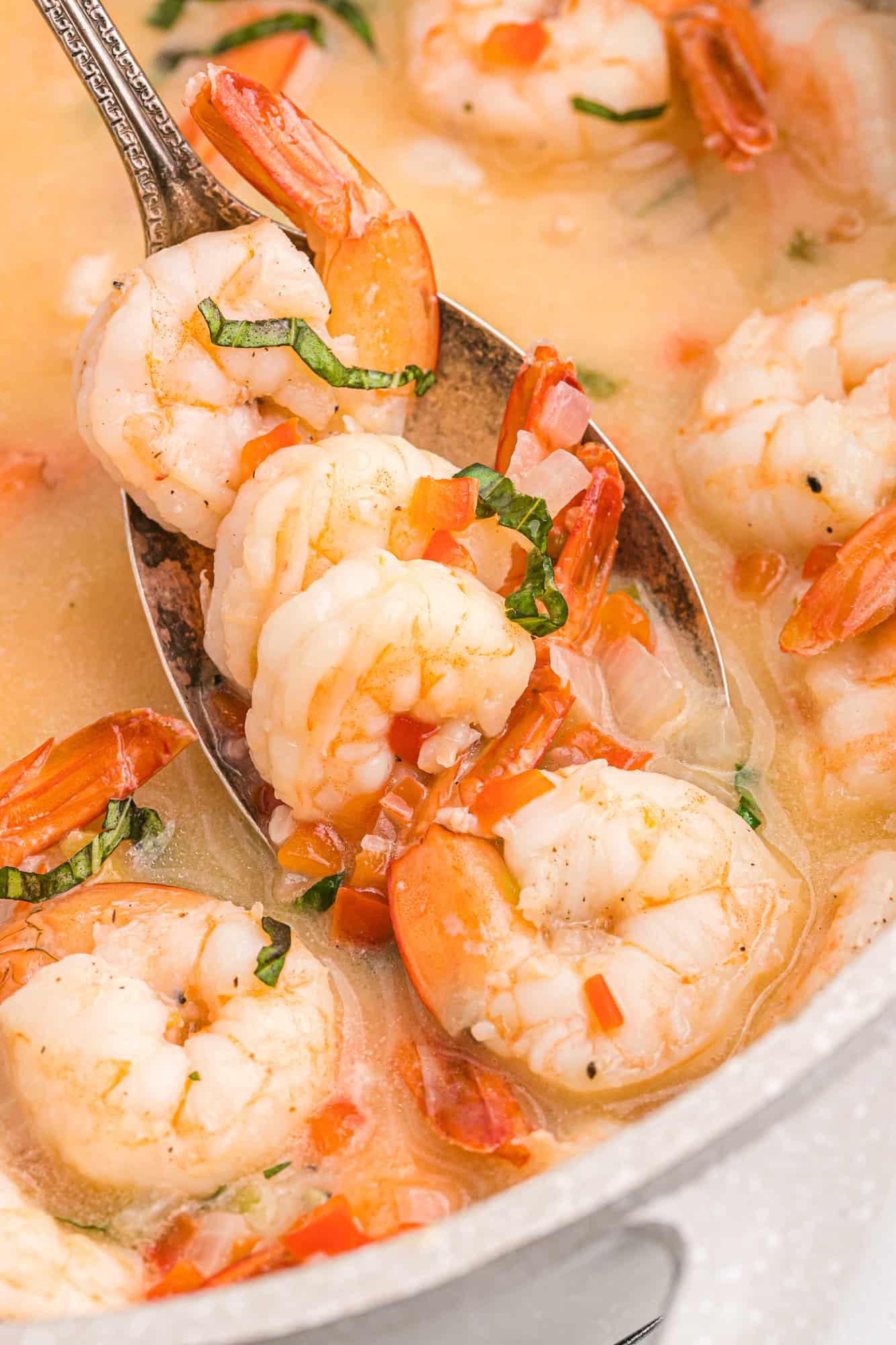 Creamy coconut shrimp on a serving spoon.