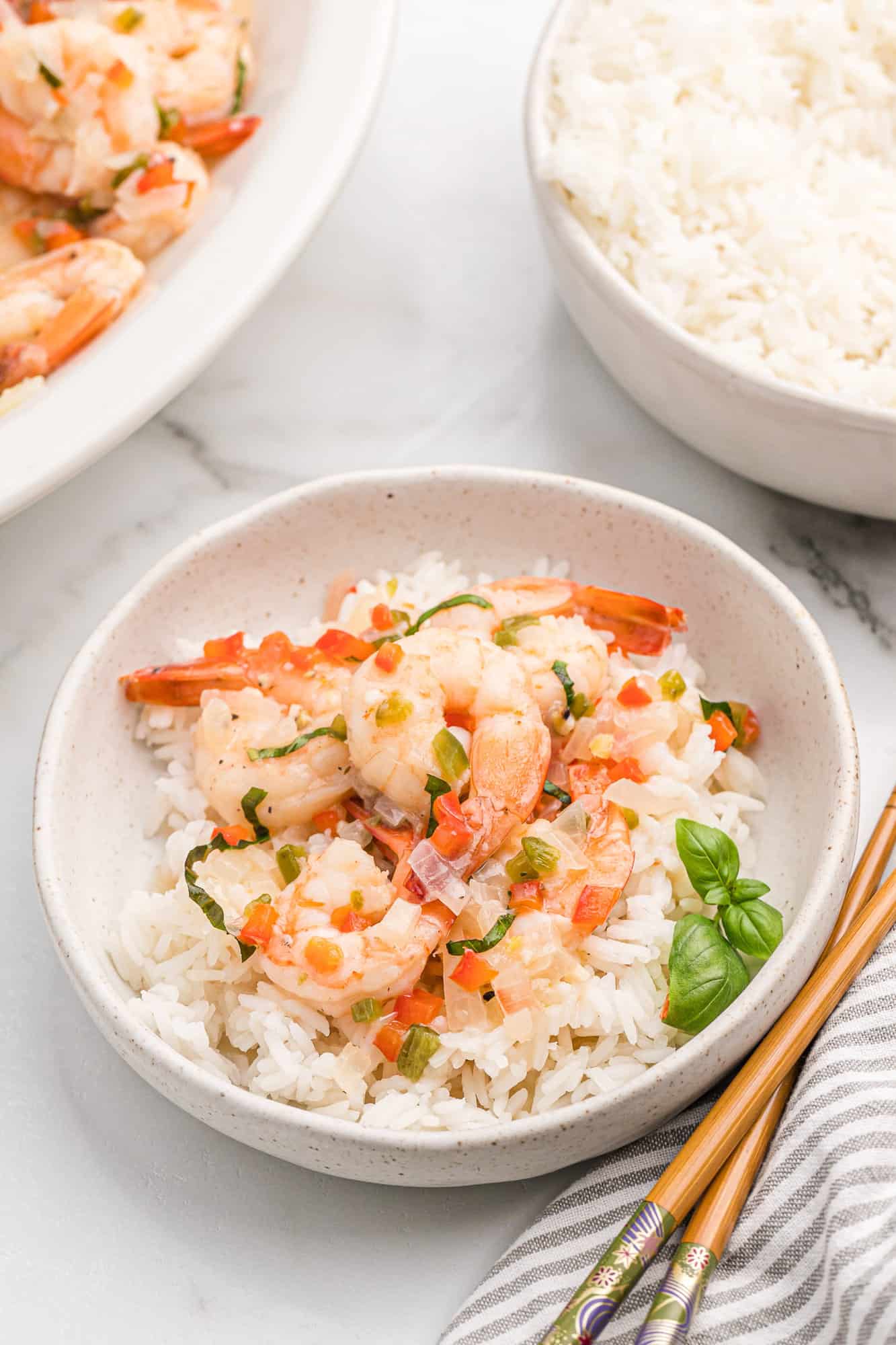 Coconut shrimp in a bowl with rice and basil.