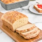 No knead whole wheat bread sliced on a cutting board.