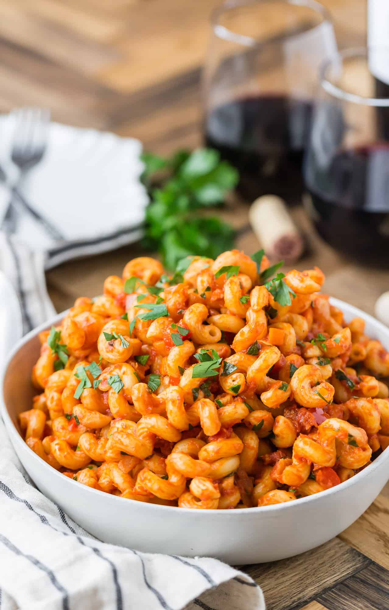 Pasta with pancetta and tomato sauce in bowl.
