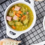 Split pea soup in a small white crock style bowl.