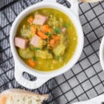 Split pea soup in a small white crock style bowl.