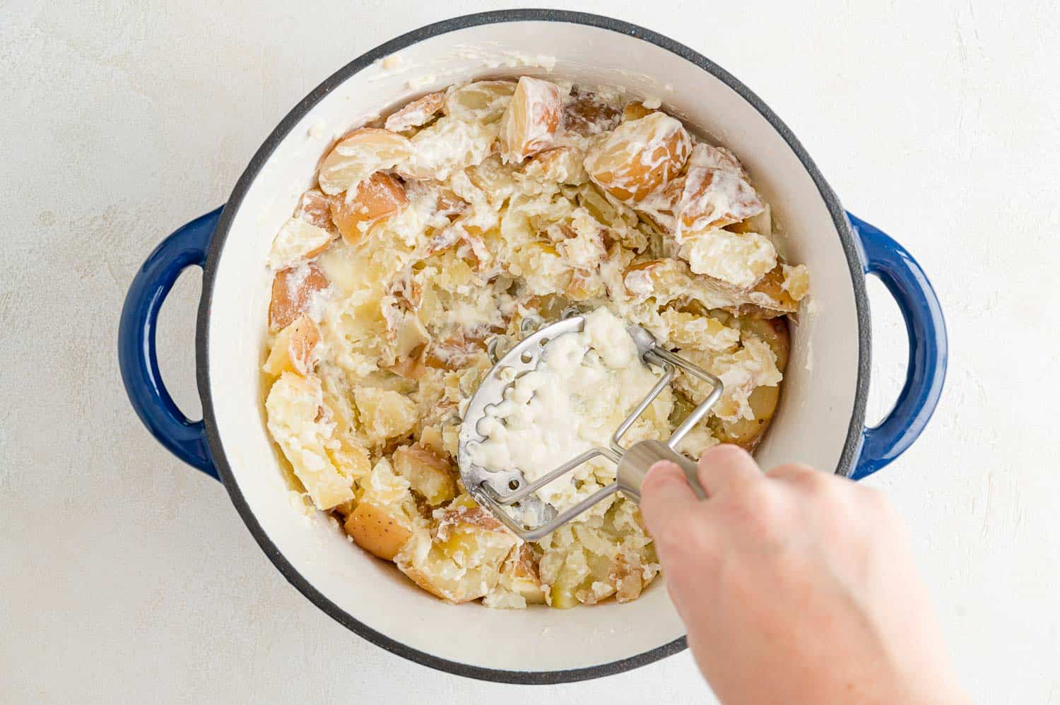 Potatoes being mashed.