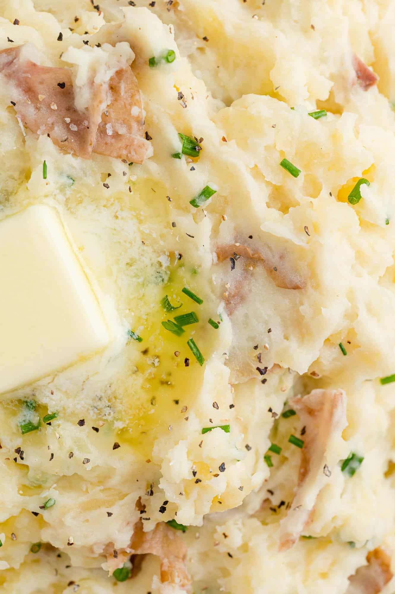 Close up view of butter melting on mashed potatoes.