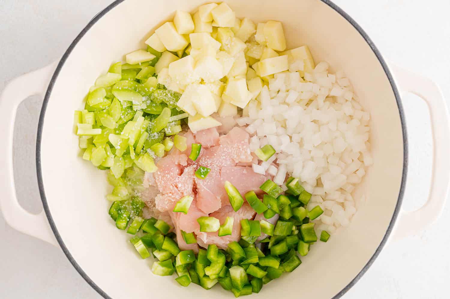 Vegetables and chicken cooking in pan.