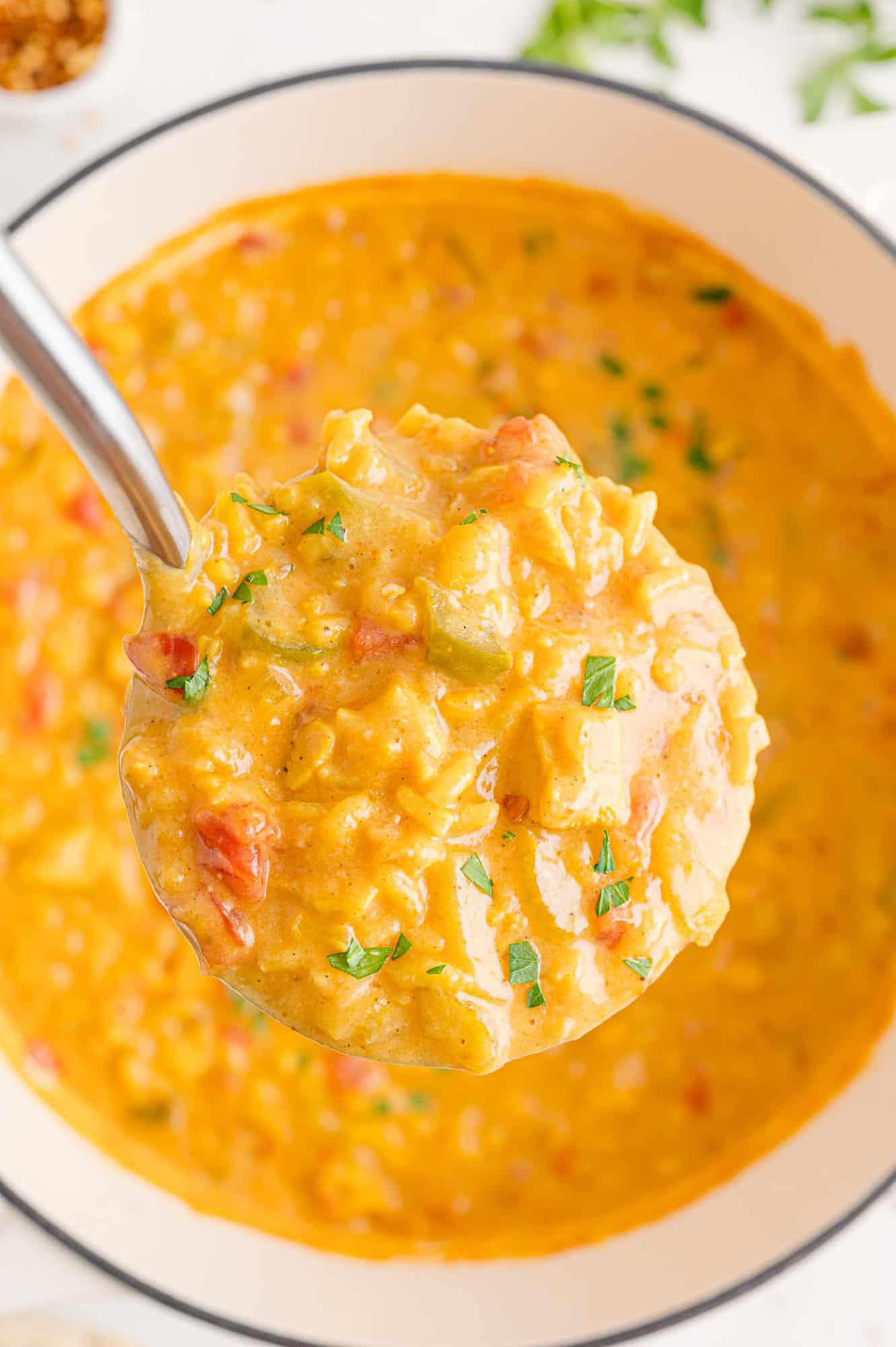 Yellow toned soup on a ladle.