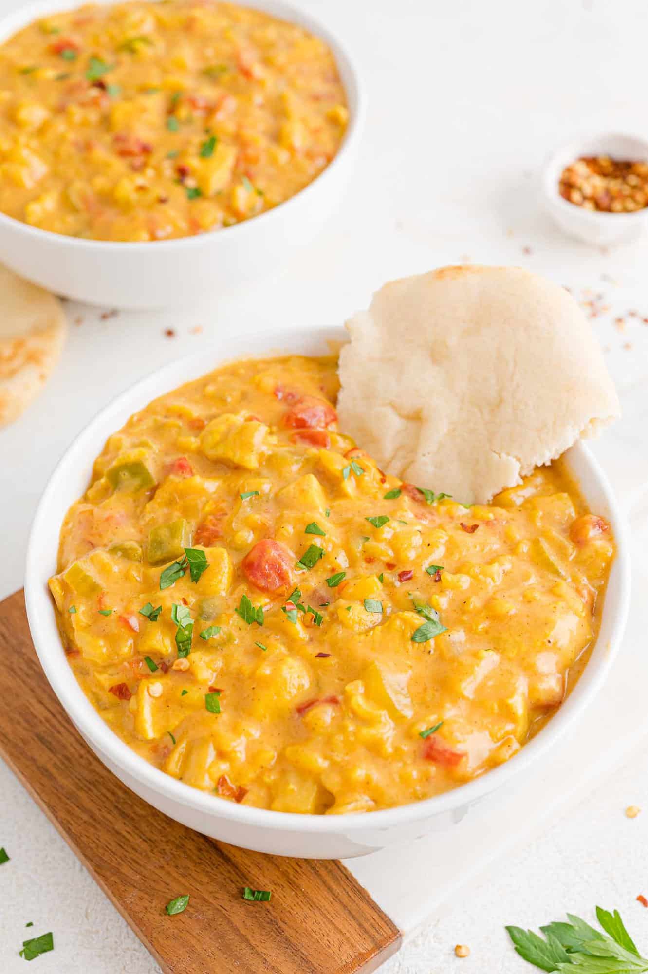 Mulligatawny soup in a bowl with naan.