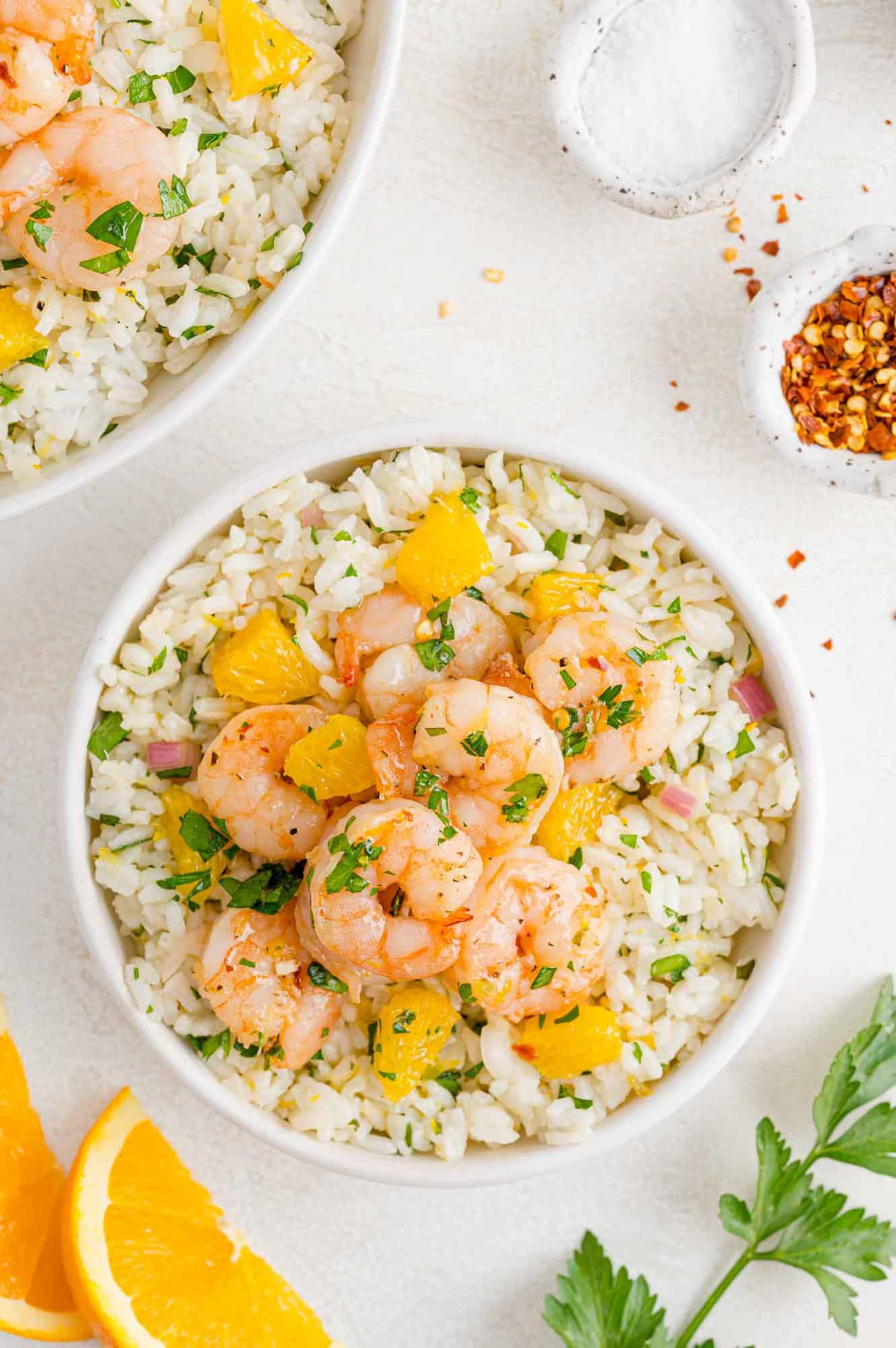 Serving bowl of rice, shrimp, and chimichurri.