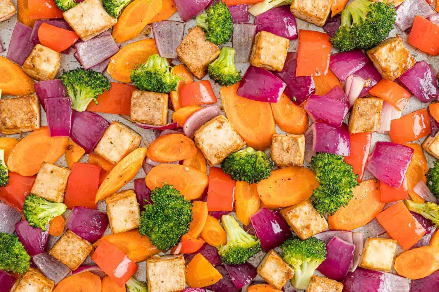 Crispy tofu and cooked vegetables, close up.