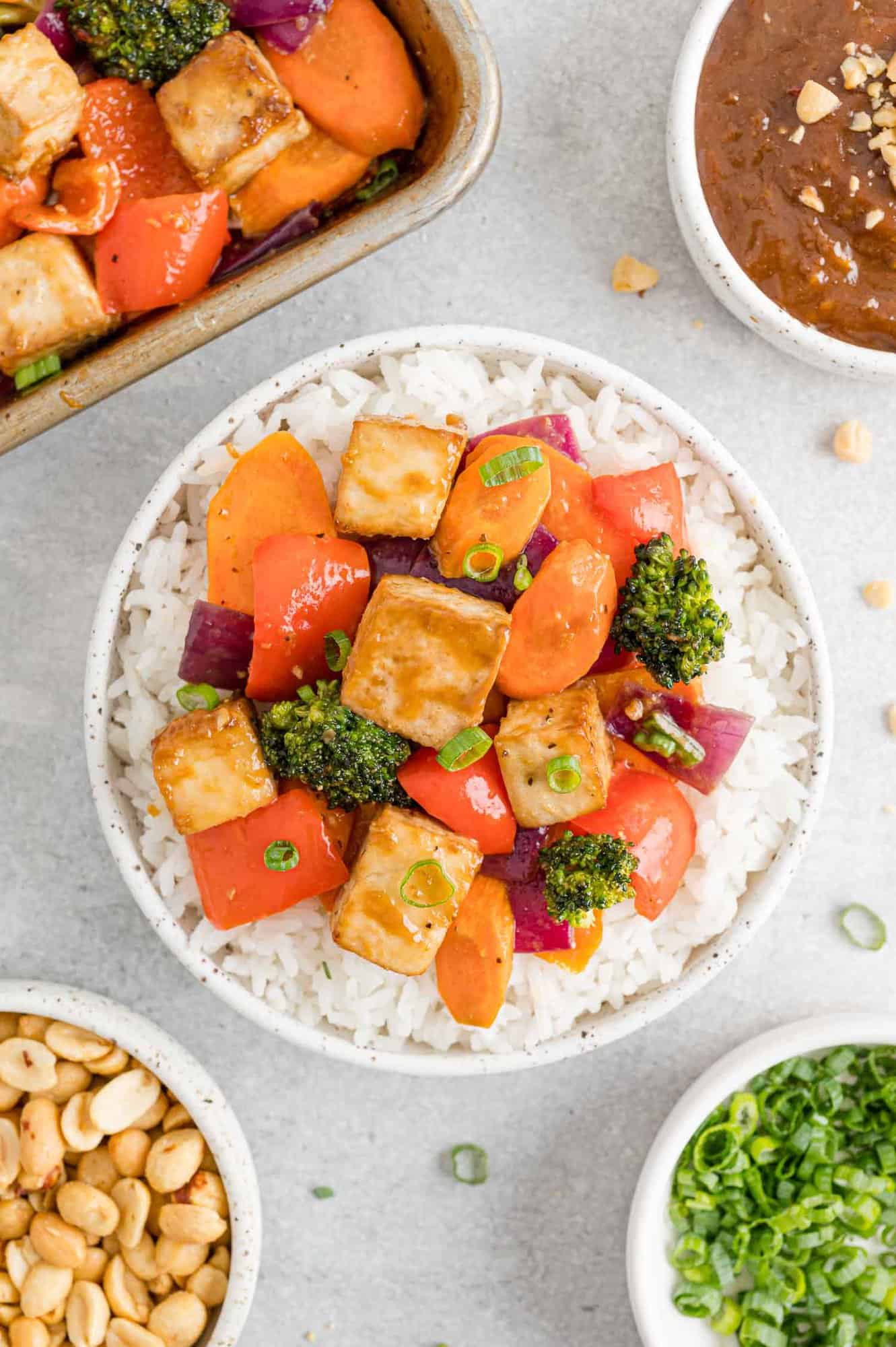 Tofu stir fry served with rice in a bowl.