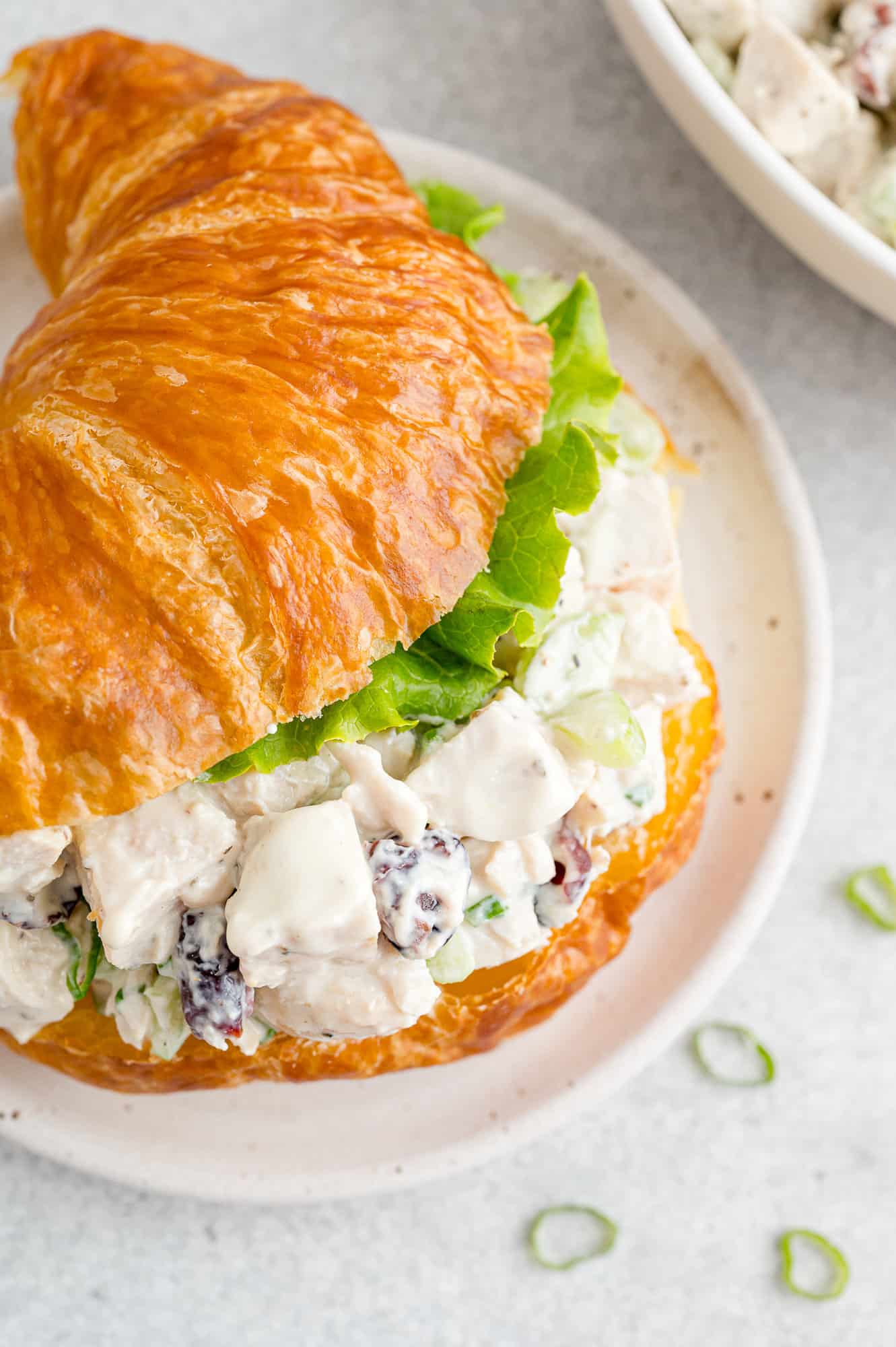 Turkey salad and leaf lettuce on a croissant.