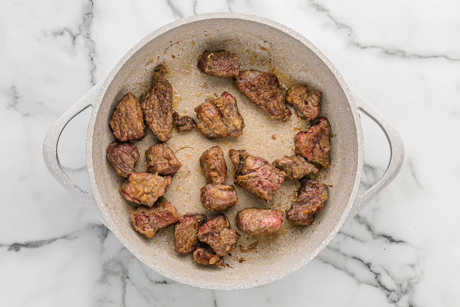 Beef cubes being browned.